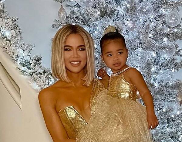 Khloe Kardashian and True Thompson Glitter in Gold at Family Christmas Party - www.eonline.com