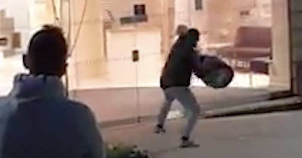Video shows man tossing beer barrel through window of town centre bank - www.dailyrecord.co.uk