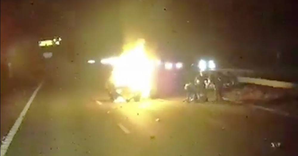 Dramatic footage shows hero lorry driver pulling woman from burning car seconds before it explodes - www.dailyrecord.co.uk