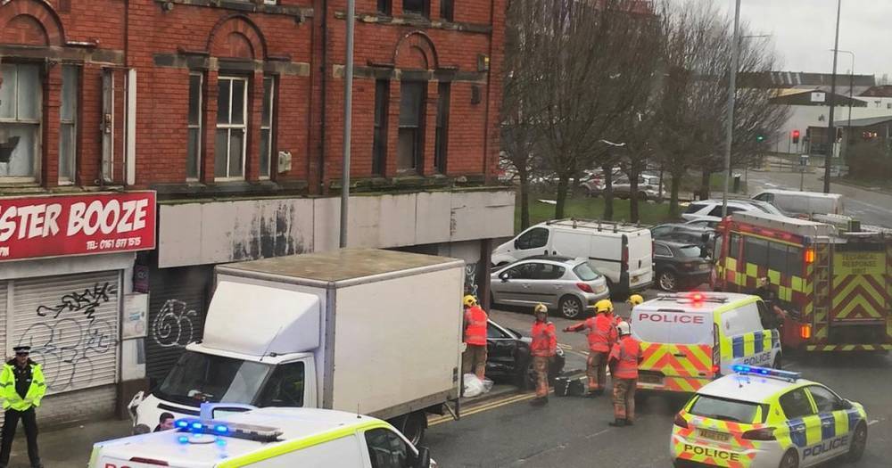 Firefighters rescue trapped woman after Audi car smashes into van and wall on Chester Road - www.manchestereveningnews.co.uk