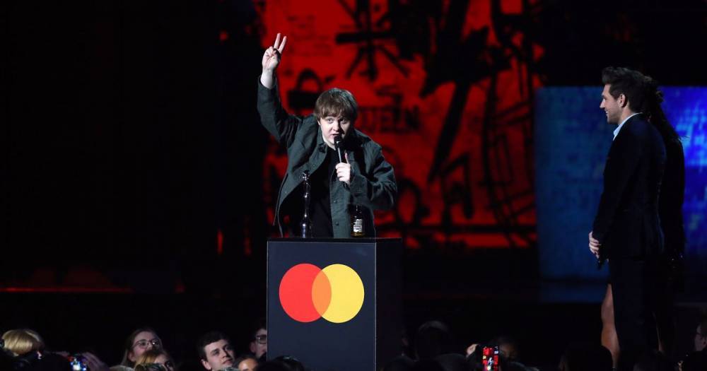 Lewis Capaldi's swigs beer as he picks up Brit award before 'sweary' speech is muted - www.dailyrecord.co.uk