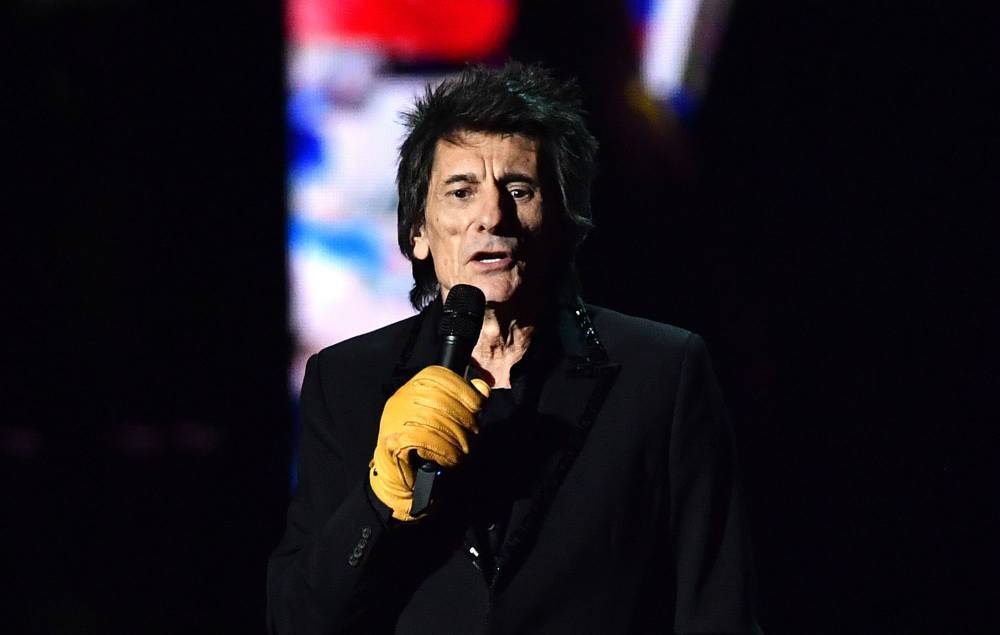 “Why is Ronnie wearing Marigolds?” — Twitter reacts to Ronnie Wood’s yellow gloves at the BRIT Awards 2020 - www.nme.com - Britain