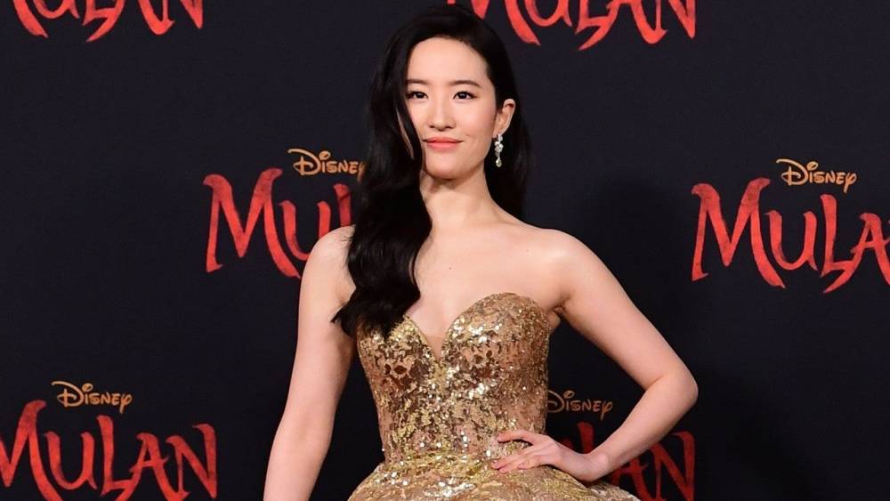 'Mulan' Star Yifei Liu on Her Regal Gold Phoenix Gown at Hollywood Premiere (Exclusive) - www.etonline.com - Hollywood