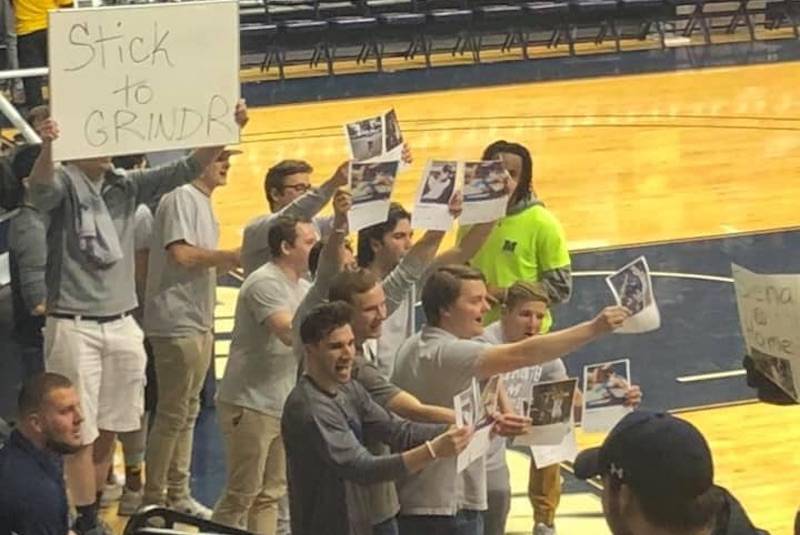 Monmouth U. basketball fans taunt rival player with photos and sign saying” Stick to Grindr” - www.metroweekly.com