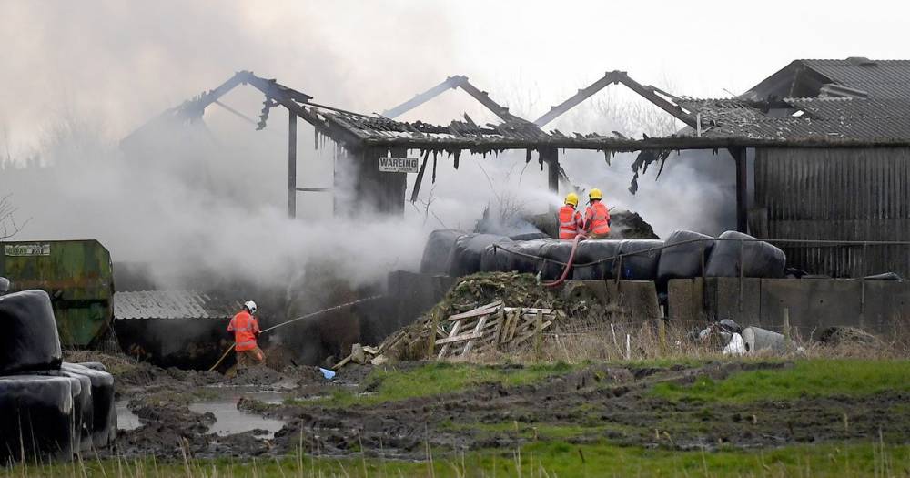 Firefighters tackling blaze involving 100 tonnes of buring hay - www.manchestereveningnews.co.uk - Manchester