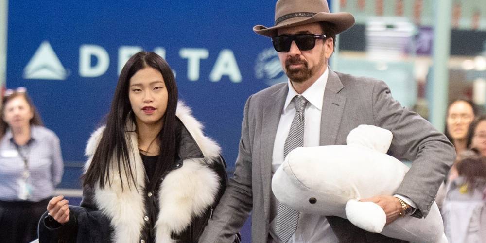 Nicolas Cage Carries a Beluga Whale Toy With New GIrlfriend Riko Shibata at the Airport in NYC - www.justjared.com - New York - Atlanta