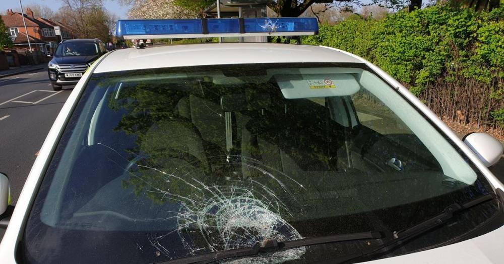 Police 'appalled and outraged' after yobs throw brick at patrol car windscreen - www.manchestereveningnews.co.uk