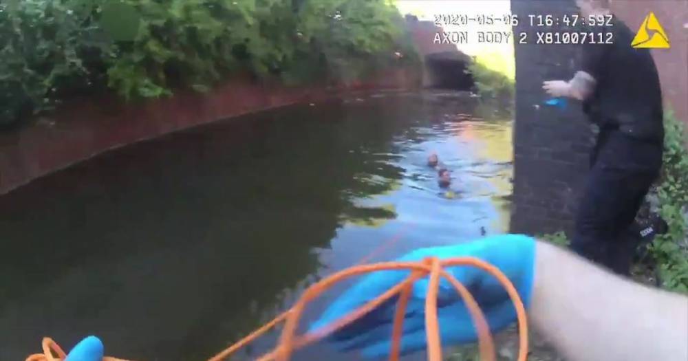 The incredible moment a hero police officer saves a man's life after diving into canal - www.manchestereveningnews.co.uk - Manchester