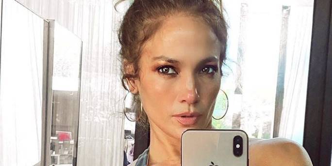 Here’s Why a Mystery Man Was “Hiding” in the Background of Jennifer Lopez’s Workout Selfie - www.cosmopolitan.com