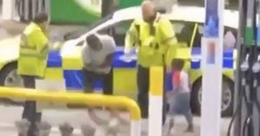 'Right... Taser him': Video shows police tasering man at petrol station in front of his young child who is repeatedly shouting 'daddy' - www.manchestereveningnews.co.uk - Manchester