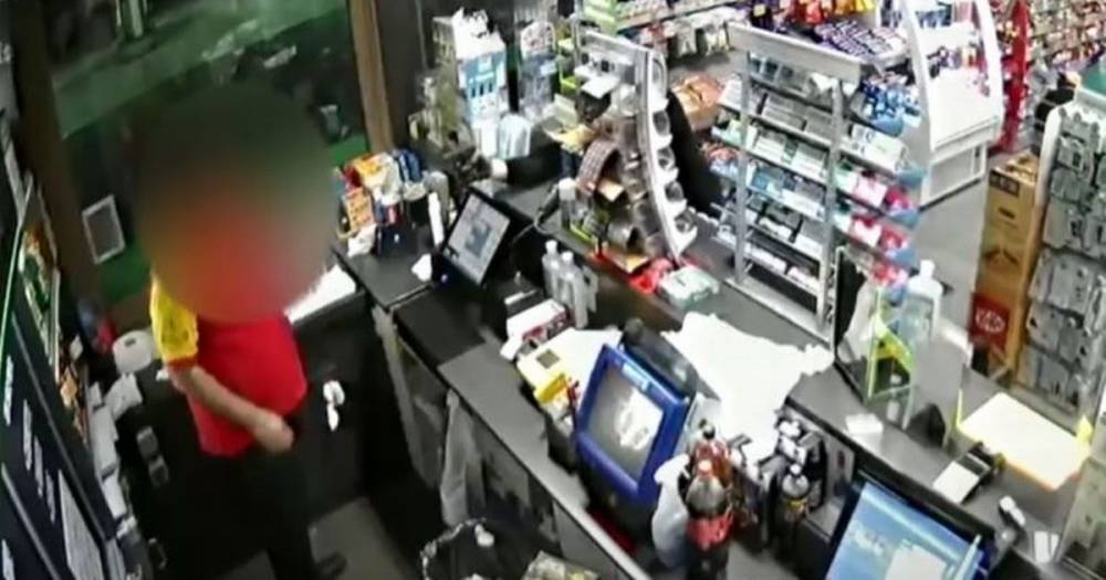 Watch shocking moment gunman robs petrol station, fires weapon and takes booze and cigarettes - www.manchestereveningnews.co.uk - Manchester