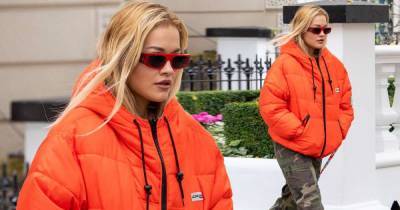 Rita Ora wraps up in a vibrant orange padded jacket on stroll - www.msn.com