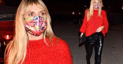 Heidi Klum looks chic in black vinyl trousers and a red knit - www.msn.com - Los Angeles