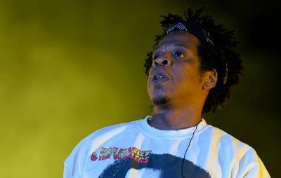 Jay-Z fan arrested after sneaking onto flight in attempt to meet the rapper - www.nme.com - Los Angeles - Chicago