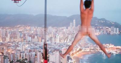 The moment a YouTuber banned from scaling Manchester's buildings hung naked from a crane in Benidorm - www.manchestereveningnews.co.uk - Spain - Manchester