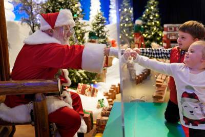 Santa struggles to spread cheer — not COVID-19 — under safety restrictions - nypost.com - New York - Santa