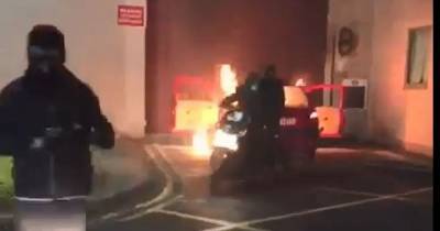 Shocking footage shows masked bikers trying to set car on fire at Forest Bank prison gates - www.manchestereveningnews.co.uk