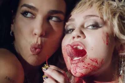 Miley Cyrus and Dua Lipa take a bloody bus ride in ‘Prisoner’ video - nypost.com - county Loving