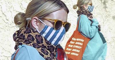Emma models leopard print scarf as she drapes bump in flowing shirt - www.msn.com