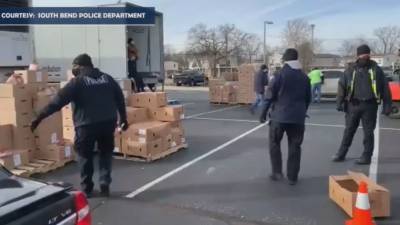 Indiana police officers distribute hundreds of boxes of food, toys to families in need - www.foxnews.com - Indiana
