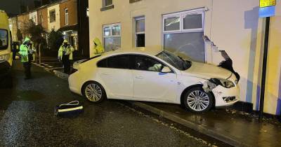 Police close major road as car smashes into home - leaving wall caved in - www.manchestereveningnews.co.uk - Manchester