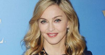Madonna's twins decorate three gingerbread houses in cheeky family video - www.msn.com