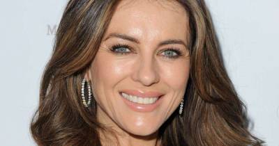Elizabeth Hurley soaks up the sun in cut-out swimsuit and cowboy hat - www.msn.com