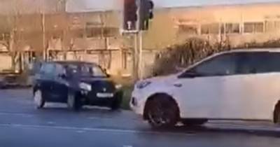 Shocking moment motorist caught driving wrong way around roundabout outside Scots police station - www.dailyrecord.co.uk - Scotland