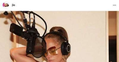 Jennifer Lopez teases new music as she poses in a tank top while in a recording booth: 'We're cookin' up something muy caliente' - www.msn.com