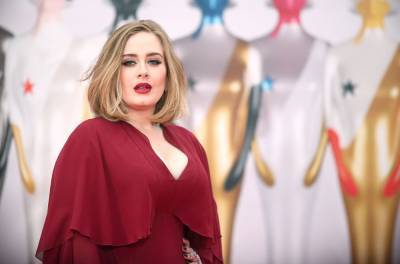 Adele Shares Mysterious Photo of Herself Performing On Stage - www.billboard.com - Britain