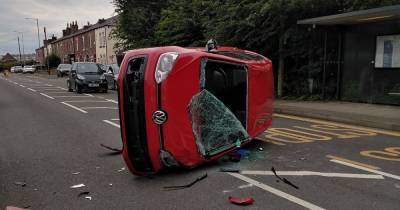 Woman in her 20s rushed to hospital after car overturns in crash - www.manchestereveningnews.co.uk