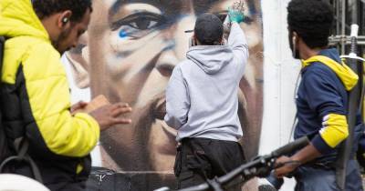 'Manchester is better than this': Street artist repairs George Floyd mural after it was daubed with vile racist graffiti - www.manchestereveningnews.co.uk - USA - Manchester