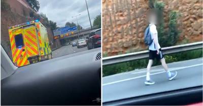 M60 traffic grinds to a halt as pedestrian criss-crosses motorway - this is the moment he was picked up by police - www.manchestereveningnews.co.uk - Manchester