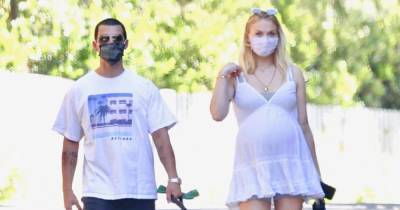 Pregnant Sophie Turner Cradles Her Baby Bump on a Walk With Joe Jonas - www.usmagazine.com
