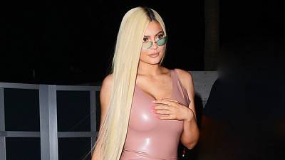Kylie Jenner Strikes Fierce Pose In A Liquid Gold Dress, Long Side Braid, Yeezy Slides - hollywoodlife.com - Poland