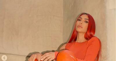 Kim Kardashian shows off toned abs and new red hair after husband Kanye West announces he’s running for US president - www.ok.co.uk - USA