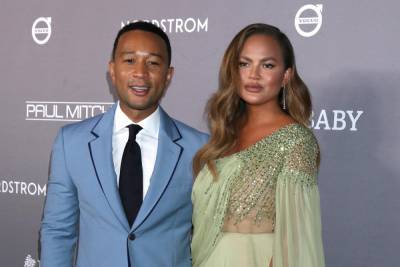 Chrissy Teigen cradles bump as she confirms third pregnancy in home video - www.hollywood.com