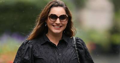 Kelly Brook flaunts her enviable legs as she gets caught in the rain in gorgeous minidress - www.ok.co.uk