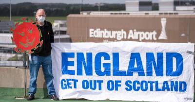 Backlash as 'despicable' pro-independence activist stages anti-English demonstration at Edinburgh Airport - www.dailyrecord.co.uk - Britain - Scotland