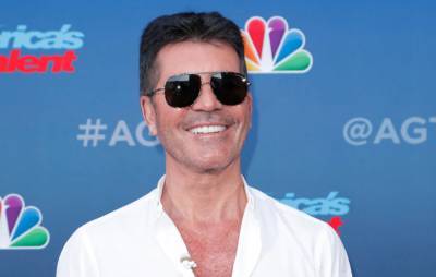Simon Cowell hospitalised after breaking his back falling off bike - www.nme.com