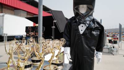 2020 Emmy Awards: First Look at Dapper Hazmat Suited Trophy Presenter - www.etonline.com