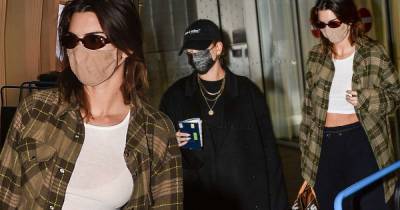 Kendall Jenner flashes her abs as she and Hailey Bieber arrive at MFW - www.msn.com