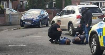 Police issue statement following two arrests after huge armed response to reports of man and woman in street with a 'crossbow and bat' - www.manchestereveningnews.co.uk - Manchester