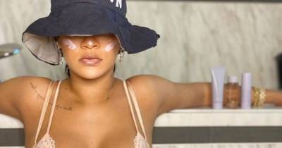 Rihanna shows off huge chest tattoo as she poses in a lace bra to plug beauty line - www.dailyrecord.co.uk - New York