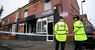 Two men in black were seen speeding away from a burning building - police think the blaze was a targeted attack - www.manchestereveningnews.co.uk