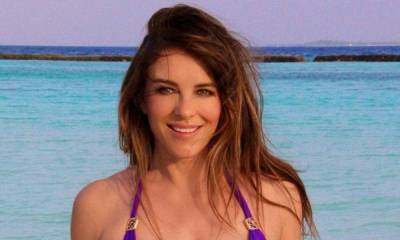 Elizabeth Hurley dances in stylish white swimsuit during beach holiday in unseen video - hellomagazine.com - Latvia - city Riga