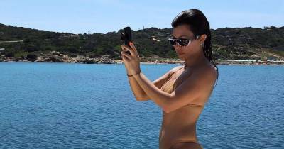 Kourtney Kardashian Shows Off Her Incredible Figure in Throwback Bikini Pics - www.usmagazine.com - Italy