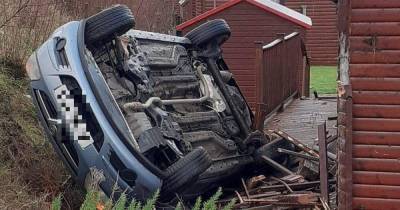 Horror crash leaves motor on roof after smashing into power lines and rolling down embankment near Scots loch - www.dailyrecord.co.uk - Scotland