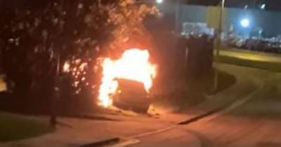 Mini Cooper bursts into flames after crashing into fence - www.manchestereveningnews.co.uk