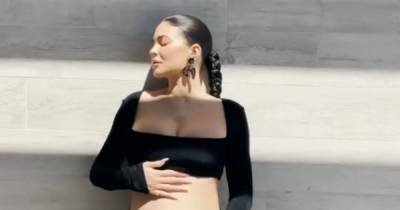 Kylie Jenner shows off blossoming baby bump with shadow snap - www.ok.co.uk